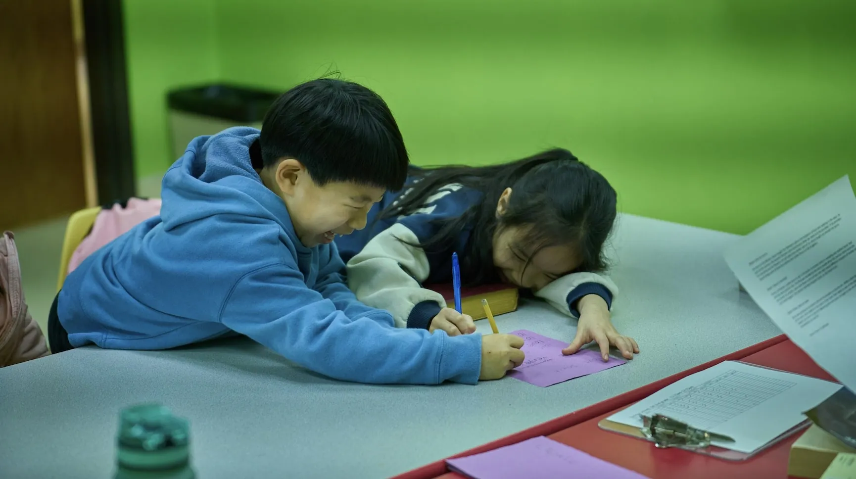Two children drawing together in a WCEC Sunday school classroom
